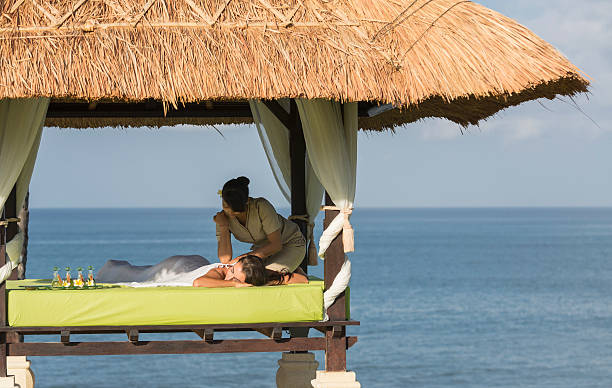 Outdoor massage under a gazebo and by the seaside.